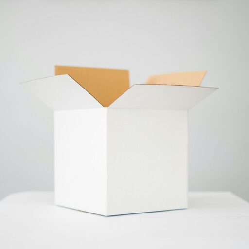 a white cardboard box on top of a white table with a white background.