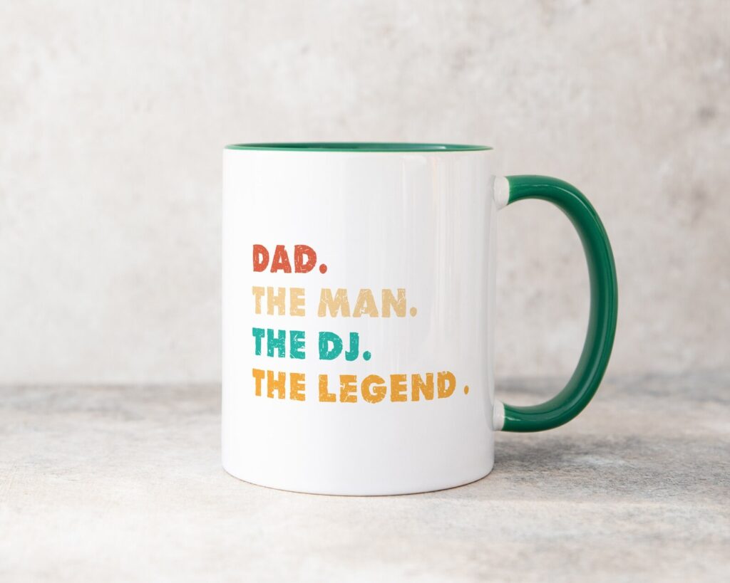 a white ceramic mug showing the text 'dad. the man. the DJ. the legend.'