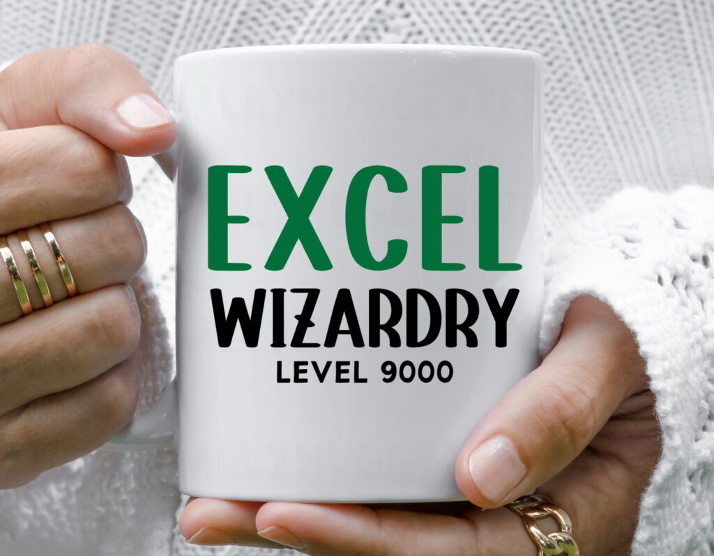 a white ceramic mug showing the text 'excel wizardry level 9000'.